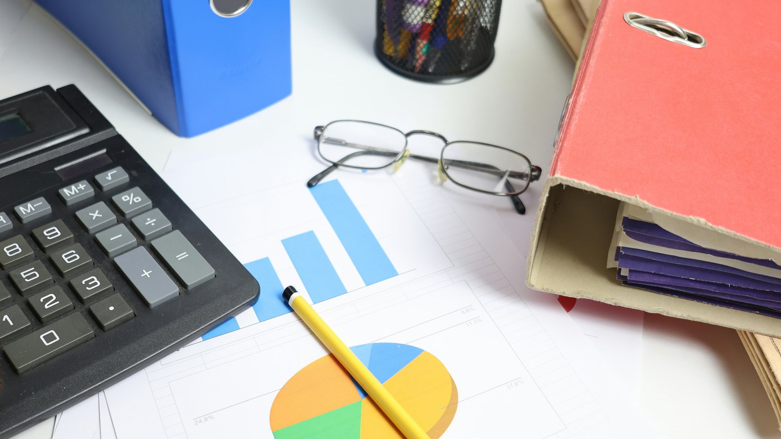 calculator, charts and binders used for forensic business diagnostics and evidence review by TobiAkiode.